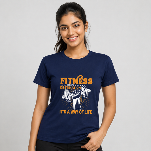 A woman wearing a navy blue graphic t-shirt with an orange and white fitness design that reads 'FITNESS IS A WAY OF LIFE' and 'IT'S A WAY OF LIFE'.
